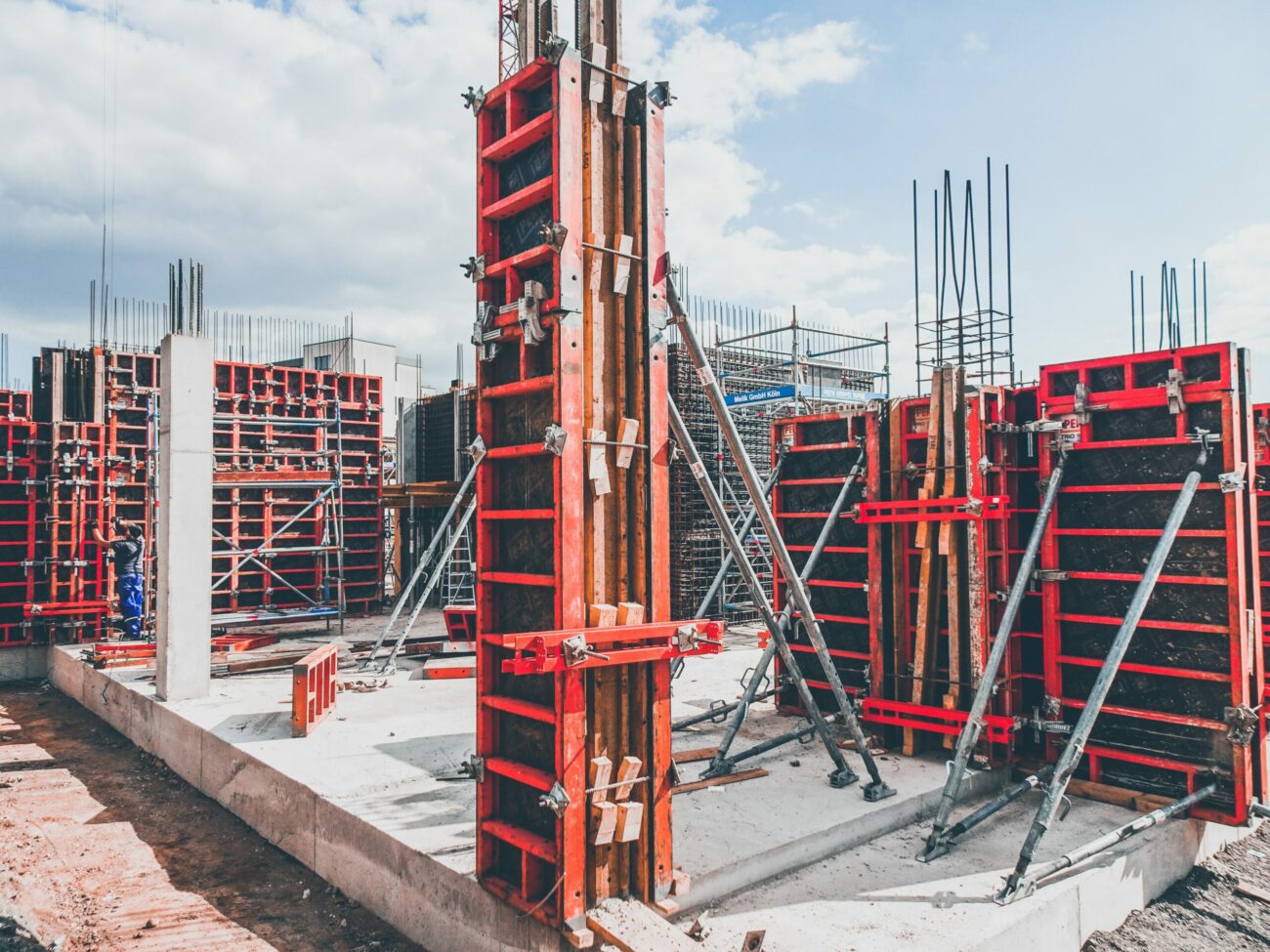 A construction project filled with half built red platforms.