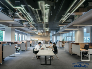 open office space with a long working table in the middle