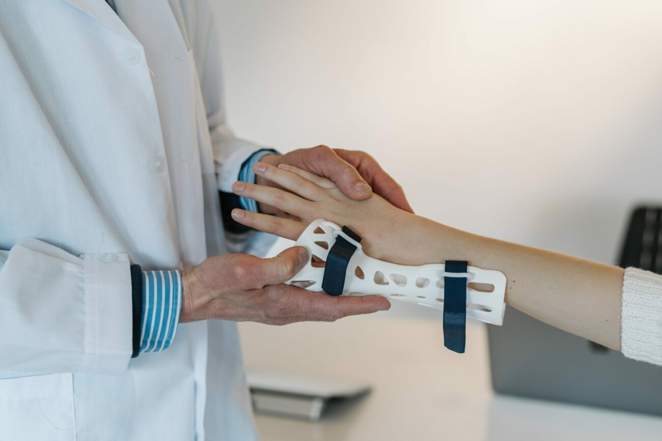 doctor holding someone's arm in a cast