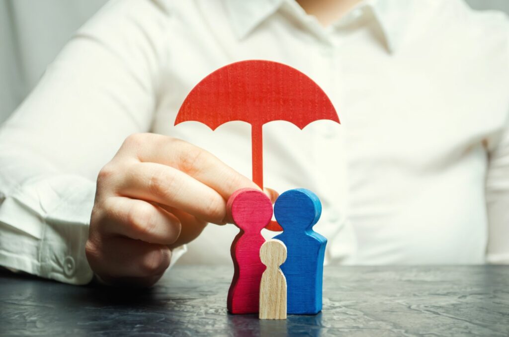 Personal insurance concept illustrated by a graphic of an umbrella shielding a family, symbolizing protection and security through proper coverage.