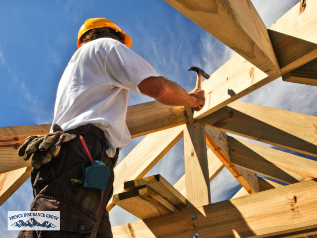 A construction worker building a new wooden structure, representing a project protected by Builders Risk Insurance during the construction process.
