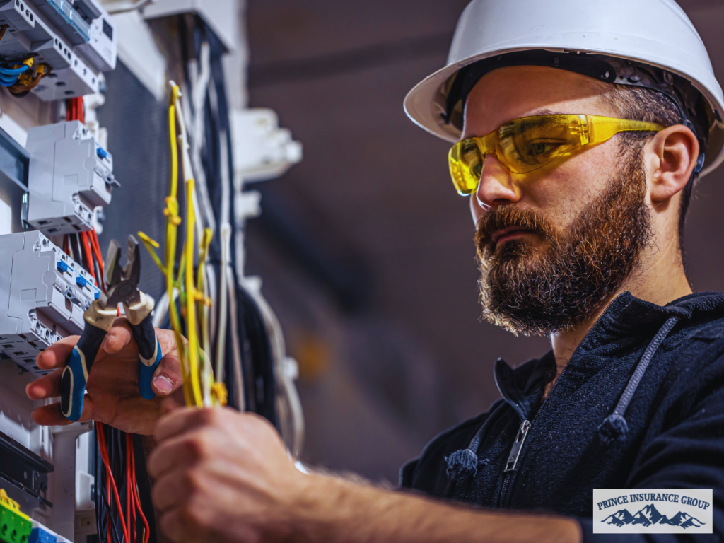 Electrician working on wiring at a job site, illustrating Artisan Contractor Insurance coverage for protecting skilled trades, tools, and work-related risks.