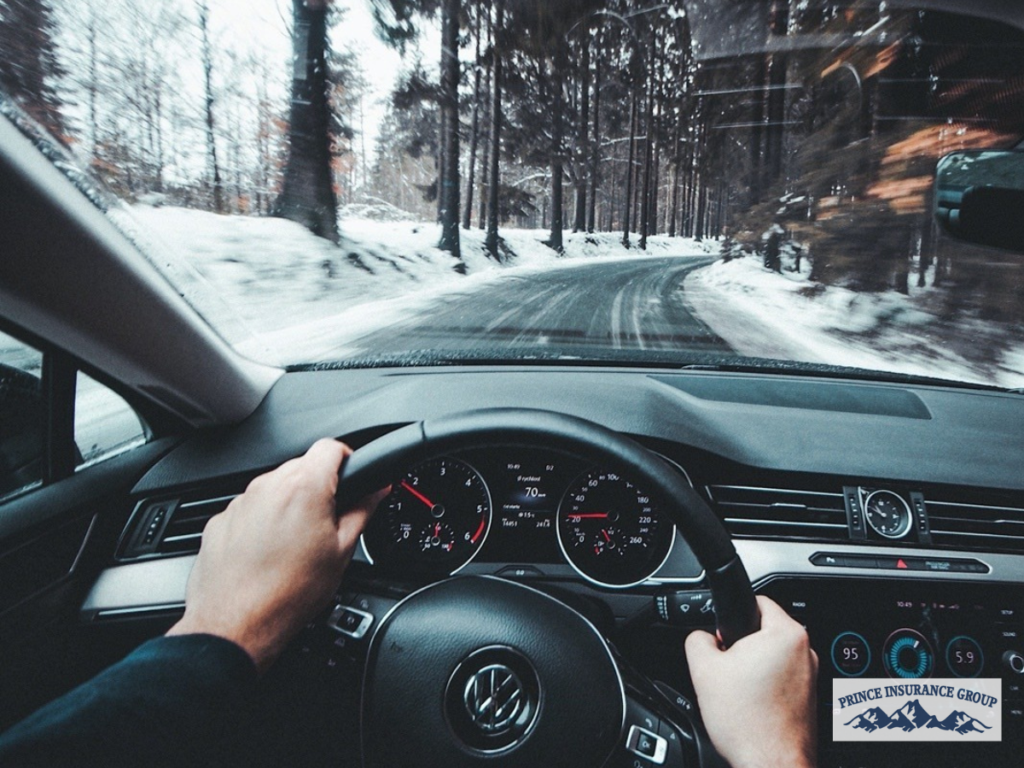 Driver holding a steering wheel inside a vehicle, representing Auto Insurance coverage that helps protect drivers, passengers, and vehicles on the road.